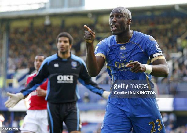 Portsmouth's English defender Sol Campbell gestures to the linesman after a penalty is given during the Premier League football match between...