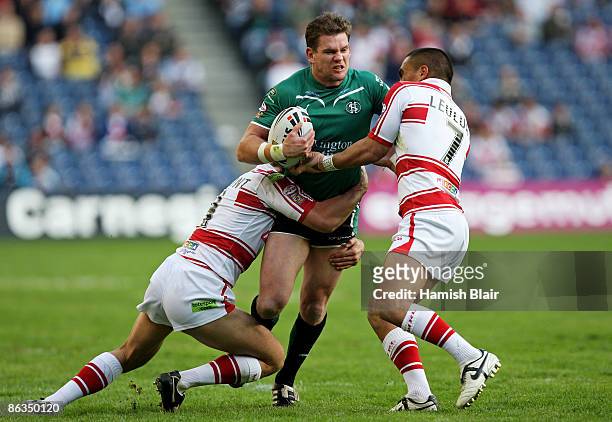 Matt Gidley of St.Helens is tackled by George Carmont and Thomas Leuluai of Wigan during the Super League Magic Weekend match between Wigan Warriors...