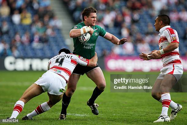 Matt Gidley of St.Helens is tackled by George Carmont and Thomas Leuluai of Wigan during the Super League Magic Weekend match between Wigan Warriors...