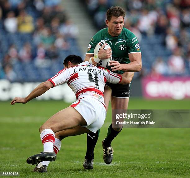 Matt Gidley of St.Helens is tackled by George Carmont of Wigan during the Super League Magic Weekend match between Wigan Warriors and St.Helens at...