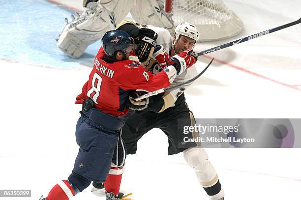 Alex Ovechkin of the Washington Capitals and Hal Gill of the Pittsburg Penguins collide during Game One of the Eastern Conference Semifinals of the...