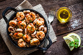 Shrimps and calamari rings cooked on iron cast pan