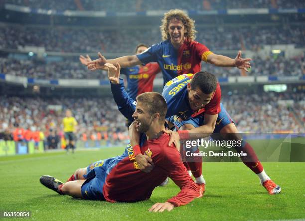 Gerard Pique of Barcelona celebrates with Dani Alves and Carles Puyol after scoring Barcelona's sixth goal during the La Liga match between Real...