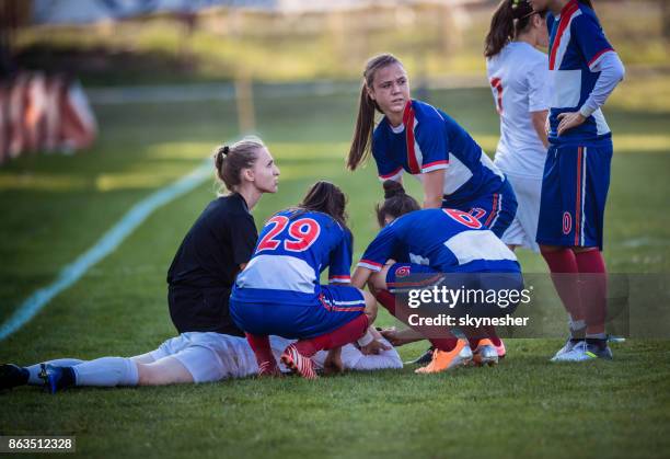 injury on women's soccer match! - soccer injury stock pictures, royalty-free photos & images