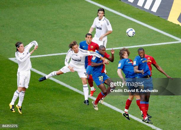 Gabriel Heinze of Real Madrid jumps with Eric Abidal , Carles Pujol and Toure Yaya of Barcelona during the La Liga match between Real Madrid and FC...