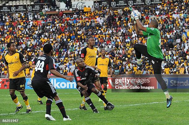 Chiefs goalkeeper Itumeleng Khune saves the ball while Pirates and Chiefs players looks on during the Absa Premiership match between Orlando Pirates...