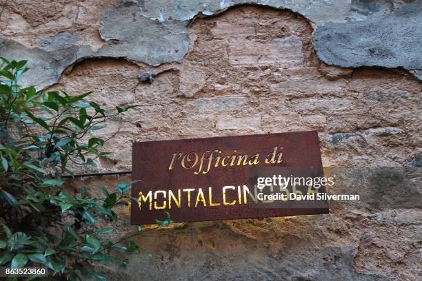 July 23: A sign for the clothing store L'officina Di Montalcino 564 is lit in the evening on July 23, 2015 in the hilltop town of Montalcino in the...