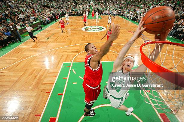 Brian Scalabrine of the Boston Celtics dunks against Derrick Rose of the Chicago Bulls in Game Seven of the Eastern Conference Quarterfinals during...