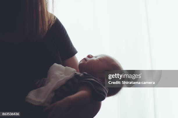 the child is in its mother's arms - shiratama camera stock pictures, royalty-free photos & images