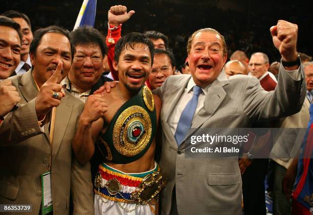 Manny Pacquiao of the Philippines celebrates with promoter Bob Arum after knocking down Ricky Hatton of England in the second round during their...