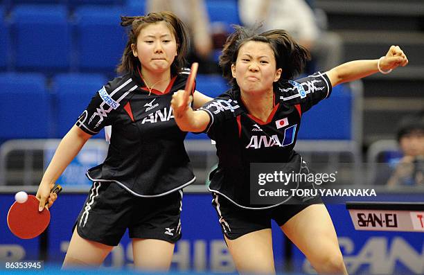 Japanese Sayaka Hirano misses a return as her partner Ai Fukuhara looks during their women's doubles quarterfinal match against Chinese Guo Yue and...