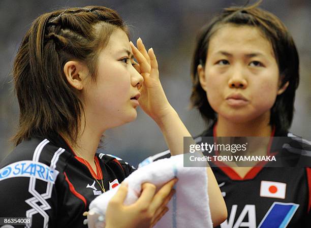 Japanese Ai Fukuhara and Sayaka Hirano react after losing a point against Chinese Guo Yue and Li Xiaoxia during their women's doubles quarterfinal...