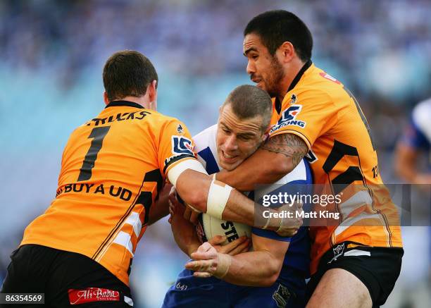 Luke Patten of the Bulldogs is tackled during the round eight NRL match between the Bulldogs and the Wests Tigers at ANZ Stadium on May 3, 2009 in...