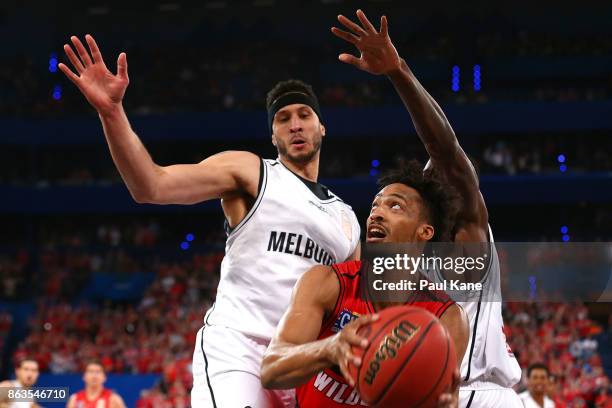 Jean-Pierre Tokoto of the Wildcats works to the basket against Josh Boone and Casey Prather of United during the round three NBL match between the...