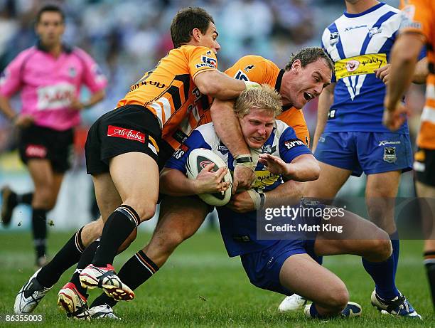 Ben Hannant of the Bulldogs is tackled during the round eight NRL match between the Bulldogs and the Wests Tigers at ANZ Stadium on May 3, 2009 in...