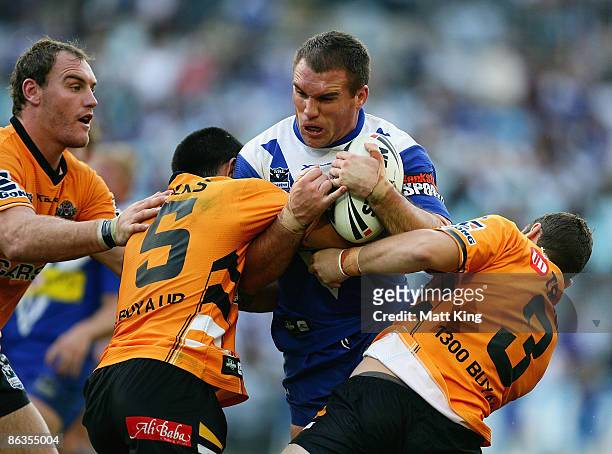 Chris Armit of the Bulldogs takes on the defence during the round eight NRL match between the Bulldogs and the Wests Tigers at ANZ Stadium on May 3,...