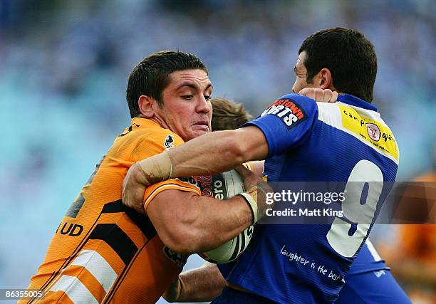 Chris Heighington of the Tigers takes on the defence during the round eight NRL match between the Bulldogs and the Wests Tigers at ANZ Stadium on May...