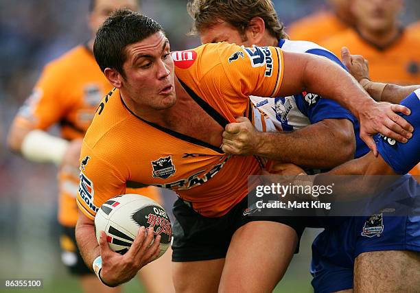 Chris Heighington of the Tigers takes on the defence during the round eight NRL match between the Bulldogs and the Wests Tigers at ANZ Stadium on May...