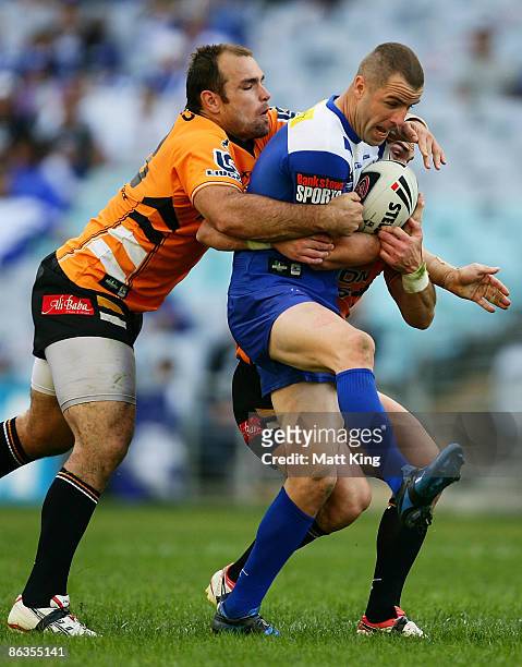 Luke Patten of the Bulldogs is tackled during the round eight NRL match between the Bulldogs and the Wests Tigers at ANZ Stadium on May 3, 2009 in...