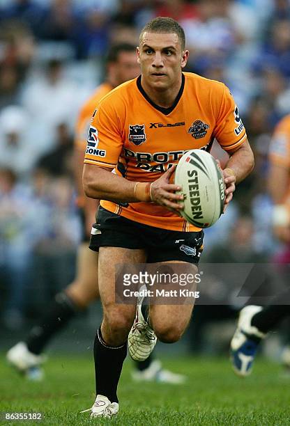 Robbie Farah of the Tigers runs with the ball during the round eight NRL match between the Bulldogs and the Wests Tigers at ANZ Stadium on May 3,...