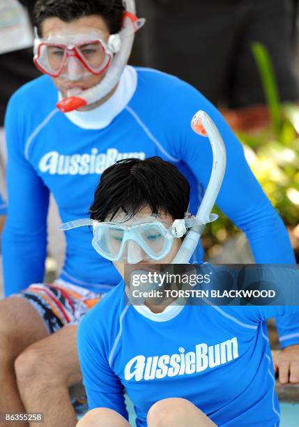 The 'Best Job In The World' finalists Clarke Gayford of New Zealand and Clare Wang of Taiwan prepare to demonstrate their ability to swim on Hamilton...