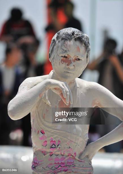 Participant is seen covered in mud during a women's mud wrestling match on May 3, 2009 in Wuhan of Hubei Province, China. About 40 women take part in...