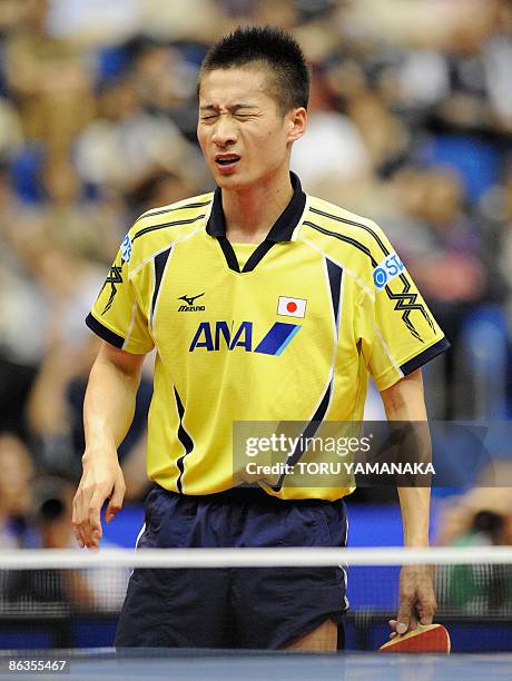 Japanese Kaii Yoshida reacts after losing a point to Wang Hao of China during their men's singles quarter-final match in the World Table Tennis...