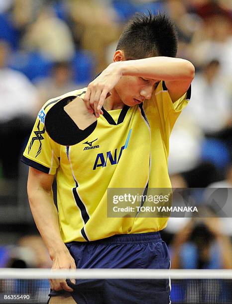 Japanese Kaii Yoshida reacts after losing a point to Wang Hao of China during their men's singles quarter-final match in the World Table Tennis...