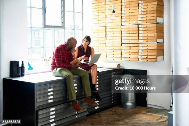 people working in modern office - person-filing-cabinet stock pictures, royalty-free photos & images