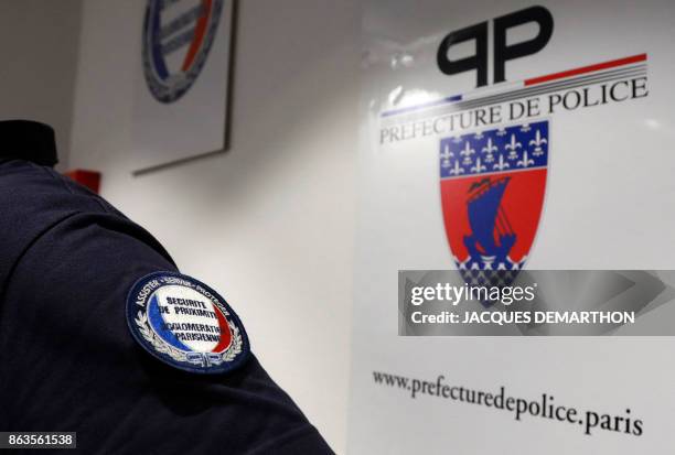 Policeman wears the logo of the regional transport police in a police station at Les Halles in Paris on October 20, 2017.