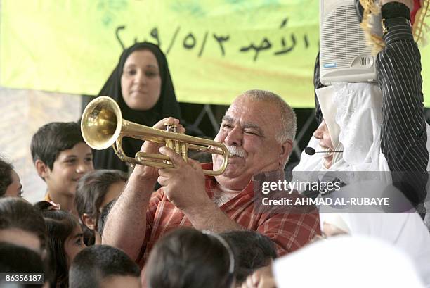 Trumpet plays as Sunni and Shiite Muslim orphans gather during a reconciliation event between orphans from the Shiite Kadhimiyah district on the west...