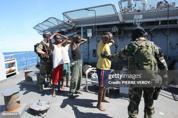 Soliders escort some of the eleven pirates on board the French warship "Le Nivose", after their capture on May 3, 2009. The French navy on Sunday...