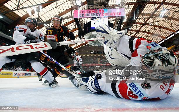 Bernd Brueckler, goalkeeper of Austria saves the puck during the IIHF World Ice Hockey Championship relegation round match between Germany and...