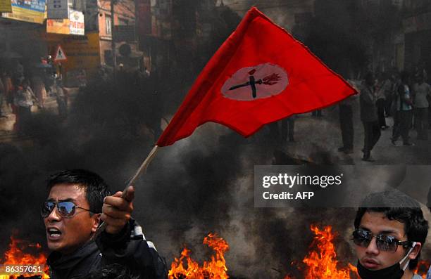 Nepalese student activists affiliated to Nepal's main opposition political party Nepali Congress burn tyres and shout anti-government slogans against...