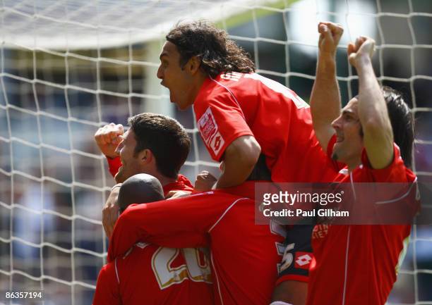 Captain Stephen Foster of Barnsley celebrates with Anderson De Silva and Jamal Campbell-Ryce after Jamal Campbell-Ryce scored the winning goal for...