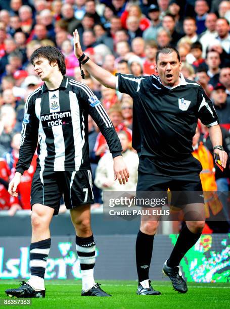 Newcastle United's English midfielder Joey Barton appeals to referee Phil Dowd as he is sent off for a foul on Liverpool's Spanish midfielder Xabi...