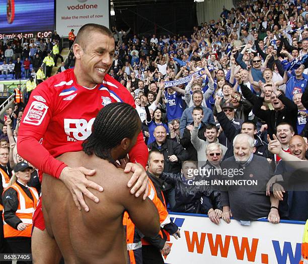 Birmingham City's Kevin Phillips is held up to the Birmingham fans by Birmingham City's Cameron Jerome at the final whistle after scoring the winning...