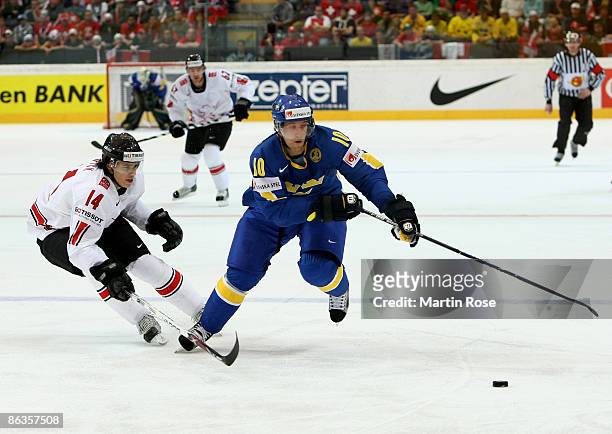 Roman Wick of Switzerland fights for the puck with Martin Thornberg of Sweden during the IIHF World Ice Hockey Championship qualification round match...
