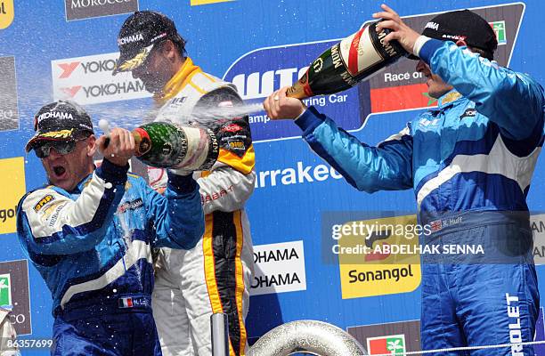 Italian Nicola Larini , French Yvan Muller and Britain's Robert Huff celebrate on the podium of Marrakech WTCC Fia World Touring Car championship on...