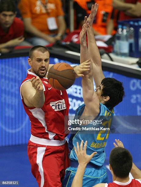 Ersan Ilyasova of Barcelona challenges for the ball with Nikola Vujcic of Piraeus during the Euroleague Basketball Final Four Third Place Play-off...