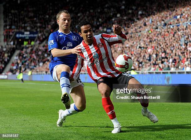 Kieran Richardson of Sunderland is tackled by Lars Jacobsen of Everton during Barclays Premier League match between Sunderland and Everton at the...
