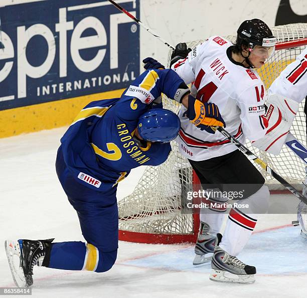 Roman Wick of Switzerland tackles Nicklas Grossman of Sweden during the IIHF World Ice Hockey Championship qualification round match between...