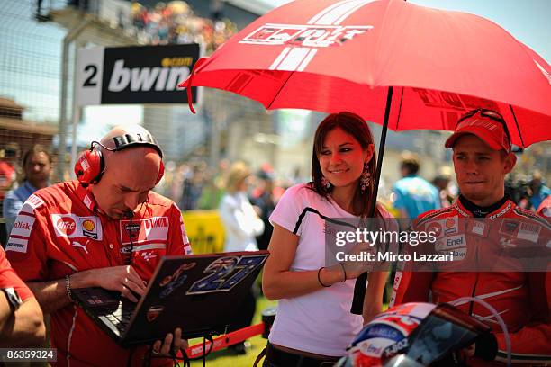 Casey Stoner of Australia and Ducati Malboro Team and his wife Adriana Stoner wait on the starting grid before the MotoGP race in MotoGP of Jerez on...