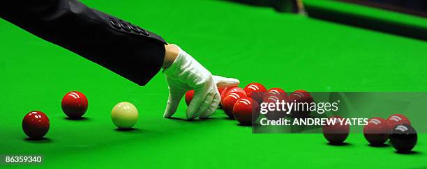 Female referee Michaela Tabb respots the pink ball during the World Championship Snooker final between Scotland's John Higgins and Britains Shaun...