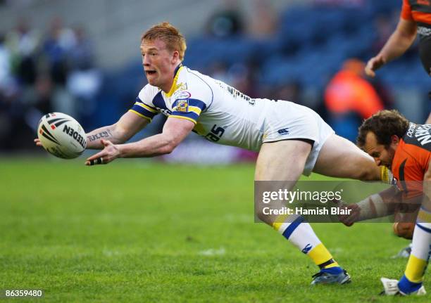 Chris Riley of Warrington offloads in the tackle during the Super League Magic Weekend match between Warrington Wolves and Hull KR at Murrayfield...