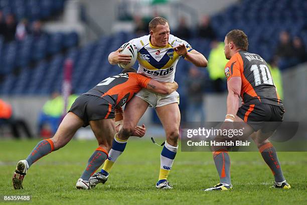 Ben Westwood of Warrington is challenged by Daniel Fitzhenry and David Mills of Hull KR during the Super League Magic Weekend match between...