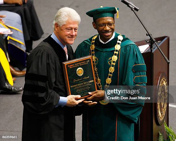 Former President Bill Clinton receives an honarary degree from Florida A&M University's President James H. Ammons during the '09 graduation at...