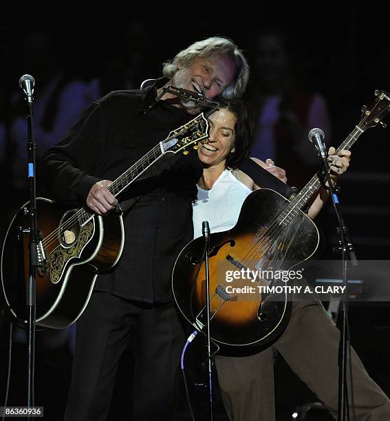 Kris Kristofferson and Ani DiFranco hug during a concert for folk music legend Pete Seeger at Madison Square Garden in New York on May 3, 2009...