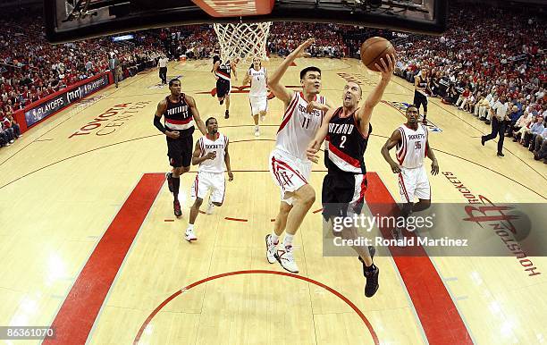 Guard Steve Blake of the Portland Trail Blazers takes a shot against Yao Ming of the Houston Rockets in Game Six of the Western Conference...