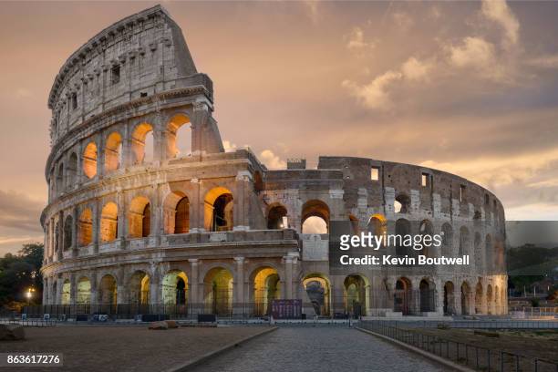 colosseum in rome at sunrise - stadium or arena or coliseum or colosseum or ring exterior or outdoor stock-fotos und bilder